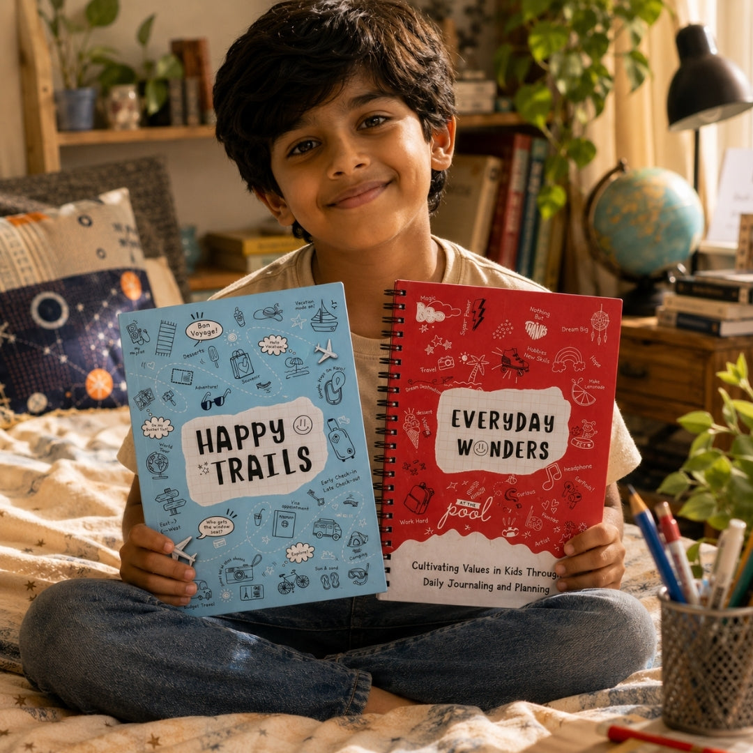 Child holding two journals titled 'Happy Trails' and 'Everyday Wonders' in a room setting.