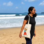 Woman holding a tote bag with a design   quote "bagging big dreams" on a beach