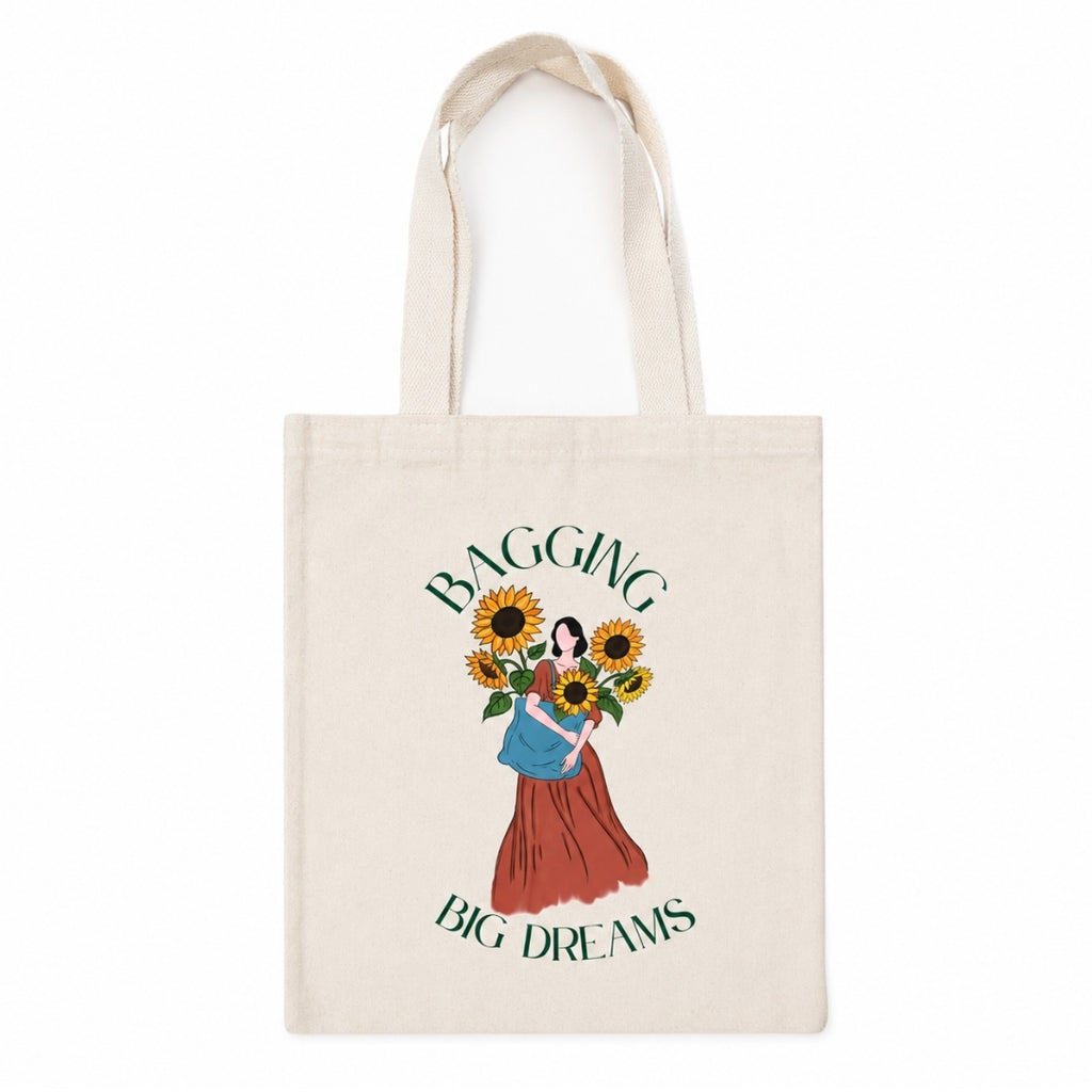 tote bag with design of a woman with flowers quoted "bagging big dreams"