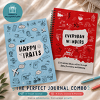Two journals, one blue and one red, with 'Happy Trails' and 'Everyday Wonders' text on a textured surface.
